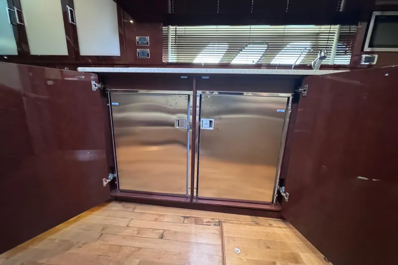 Slide: The Image of Interior of 2011 Sea Ray 540 Sundancer yacht with stainless steel appliances and wooden cabinetry. - 44