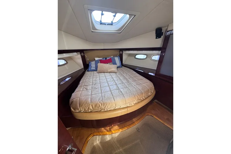 Slide: The Image of Luxurious cabin interior of 2011 Sea Ray 540 Sundancer yacht with skylight and cozy bedding. - 48