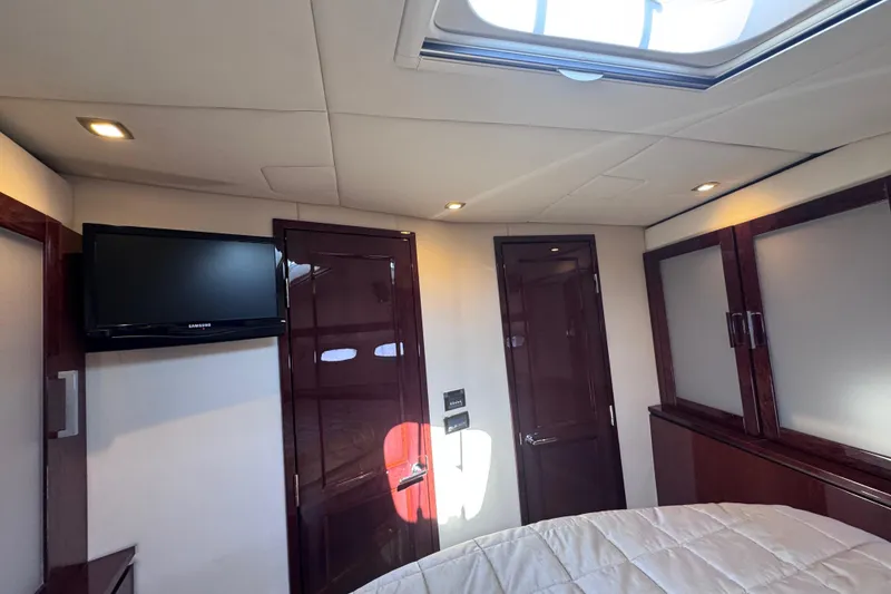 Slide: The Image of Luxurious interior of 2011 Sea Ray 540 Sundancer yacht cabin with TV and skylight. - 51