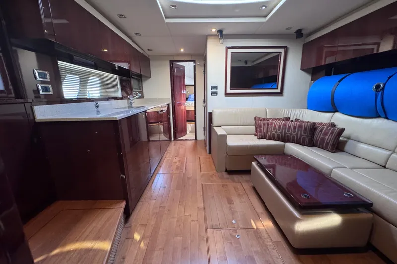Slide: The Image of Luxurious interior of 2011 Sea Ray 540 Sundancer yacht with modern kitchen and seating area. - 58
