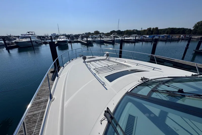 Slide: The Image of 2011 Sea Ray 540 Sundancer yacht docked at a marina under clear blue skies. - 6