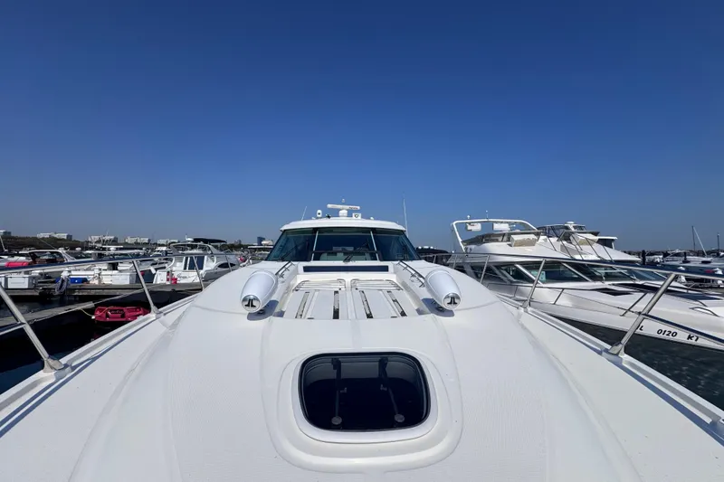 Slide: The Image of 2011 Sea Ray 540 Sundancer yacht docked in a marina under clear blue skies. - 7