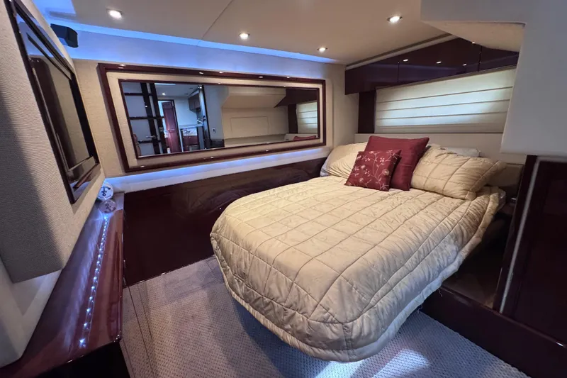 Slide: The Image of Luxurious bedroom interior of 2011 Sea Ray 540 Sundancer yacht with elegant bedding and ambient lighting. - 71