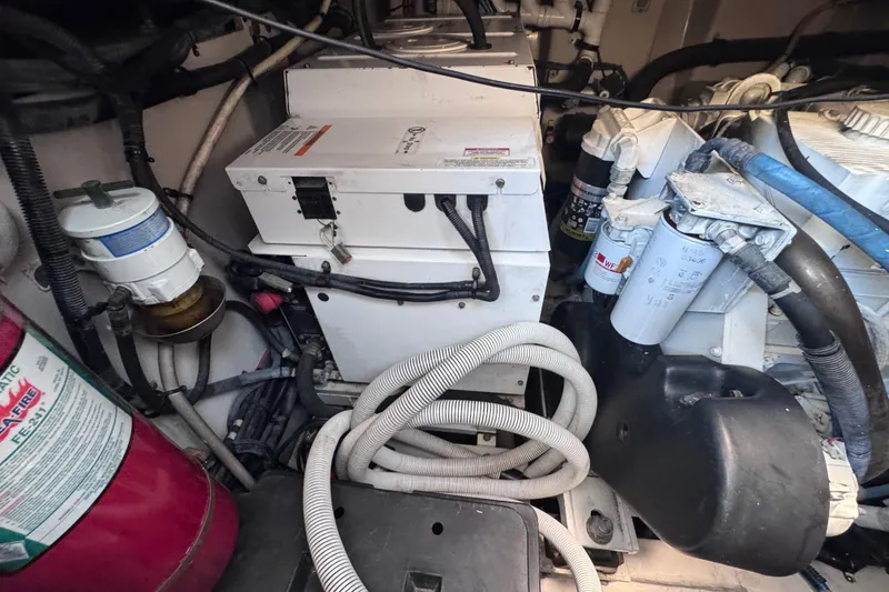 Slide: The Image of Engine room of 2011 Sea Ray 540 Sundancer with visible components and fire extinguisher. - 73