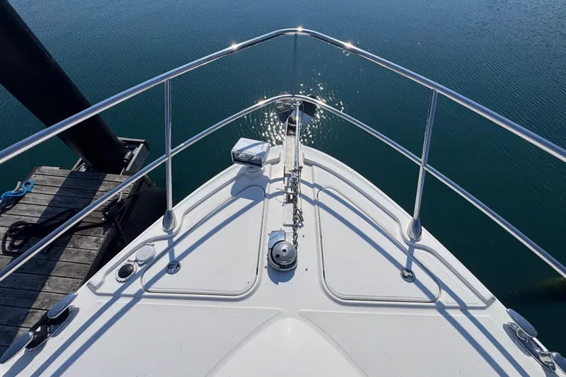 Slide: The Image of Bow view of 2011 Sea Ray 540 Sundancer yacht docked on calm water. - 8