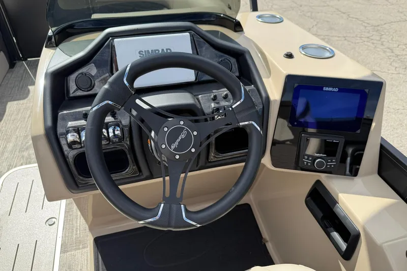 Slide: The Image of 2026 Bentley Pontoons Elite 223 QSB dashboard with steering wheel and navigation system. - 6