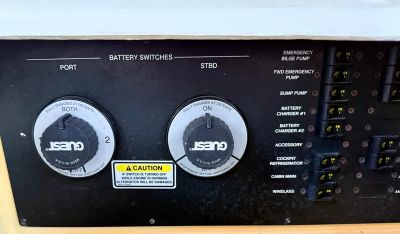 Slide: The Image of Control panel of a 2006 Sea Ray 290 Sundancer with battery switches and labeled functions. - 12