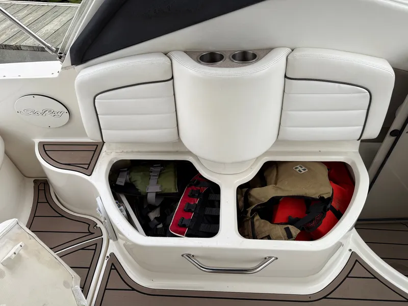 Slide: The Image of 2006 Sea Ray 290 Sundancer boat storage compartment with life jackets and gear. - 13