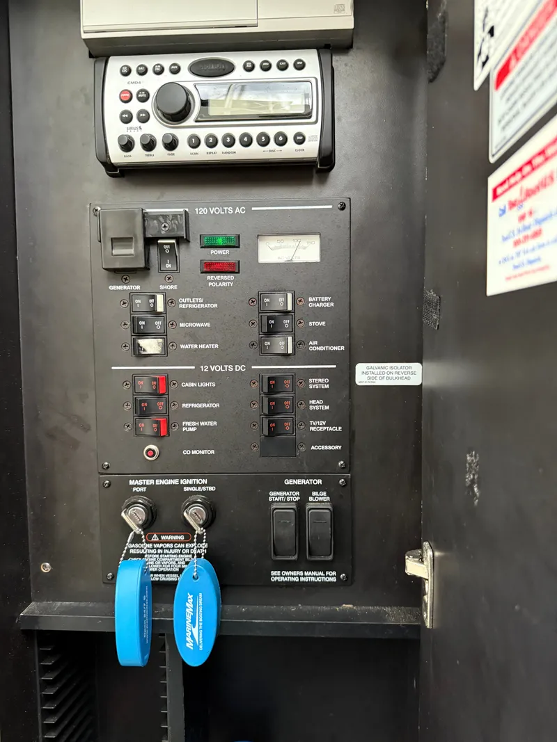 Slide: The Image of Control panel of a 2006 Sea Ray 290 Sundancer boat with various switches and a stereo system. - 15