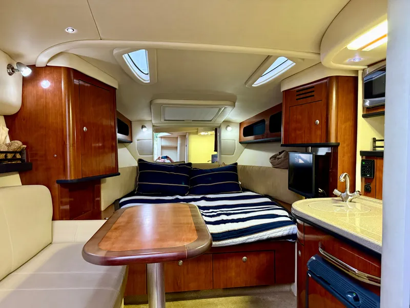 Slide: The Image of Interior of 2006 Sea Ray 290 Sundancer with cozy cabin and modern amenities. - 17