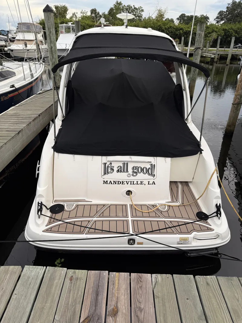 Slide: The Image of 2006 Sea Ray 290 Sundancer docked in Mandeville, LA, with black cover. - 2