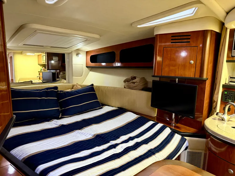 Slide: The Image of Luxurious interior of 2006 Sea Ray 290 Sundancer with cozy bed and modern amenities. - 24