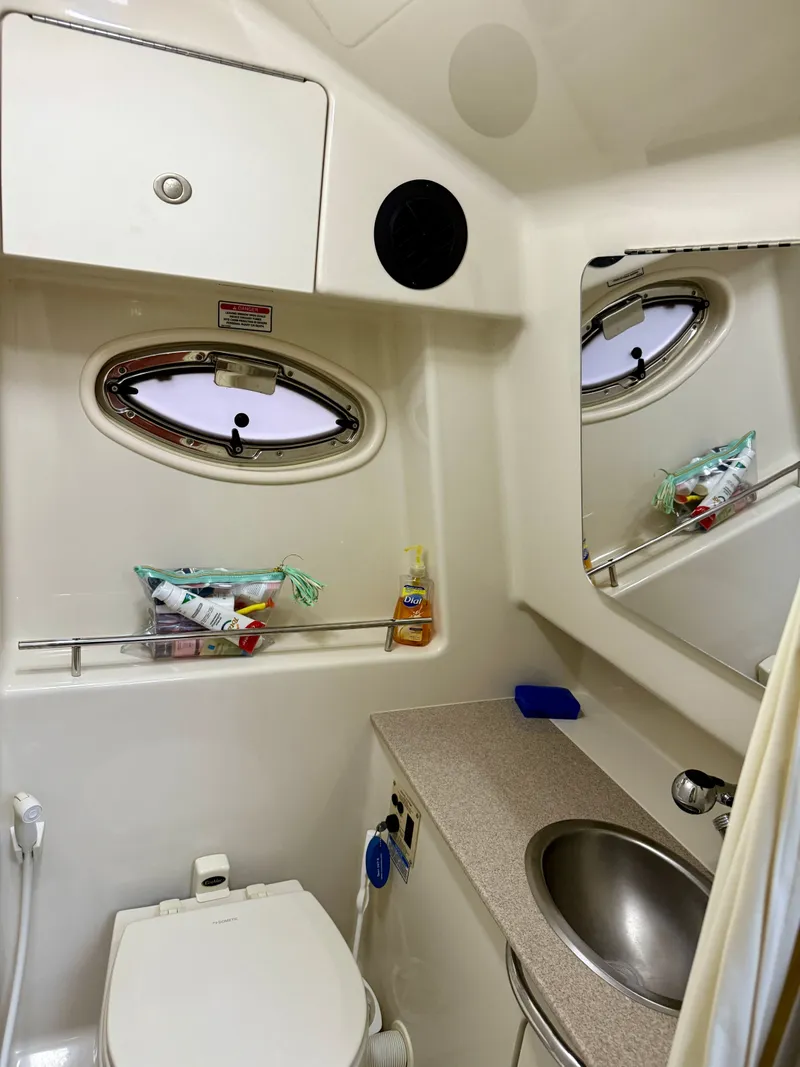 Slide: The Image of 2006 Sea Ray 290 Sundancer bathroom with sink, toilet, and storage. - 27