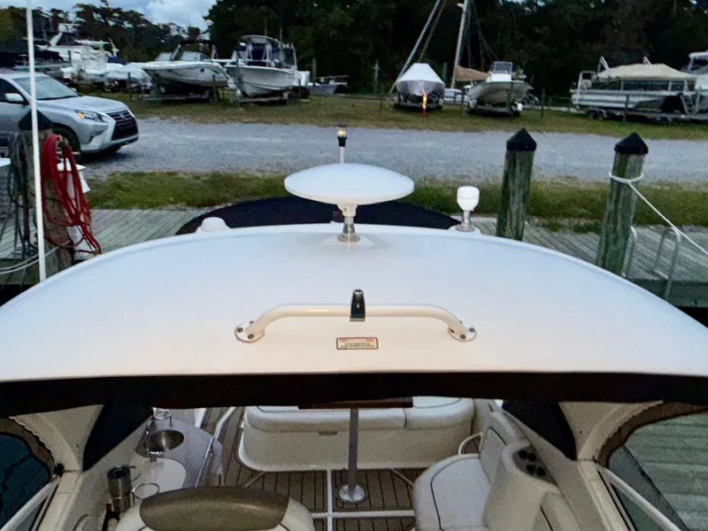 Slide: The Image of 2006 Sea Ray 290 Sundancer docked at marina with other boats in background. - 37