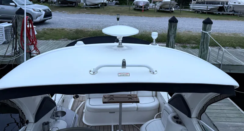 Slide: The Image of 2006 Sea Ray 290 Sundancer boat docked, featuring a spacious deck and modern amenities. - 39