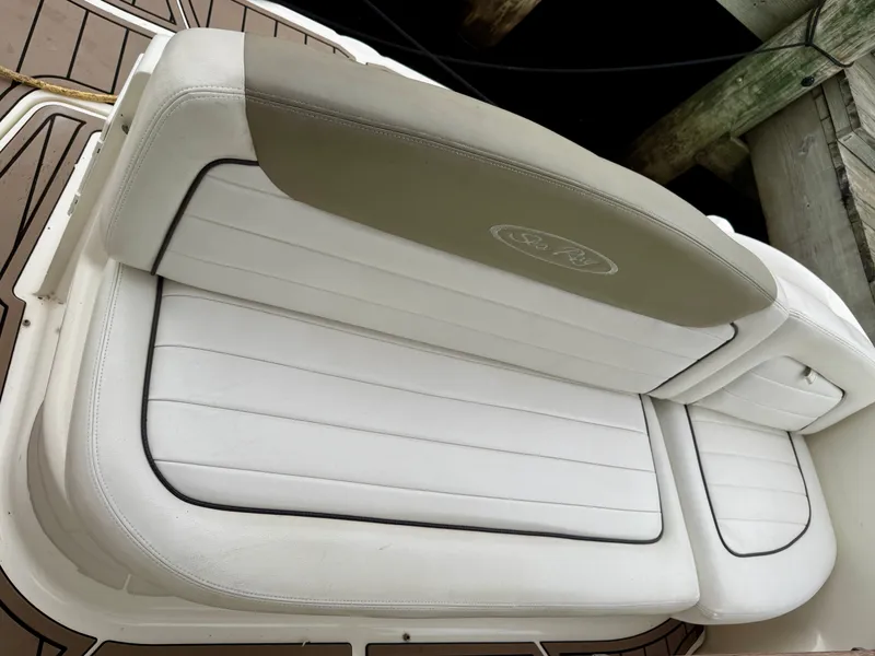 Slide: The Image of 2006 Sea Ray 290 Sundancer boat seat with white and beige upholstery. - 8