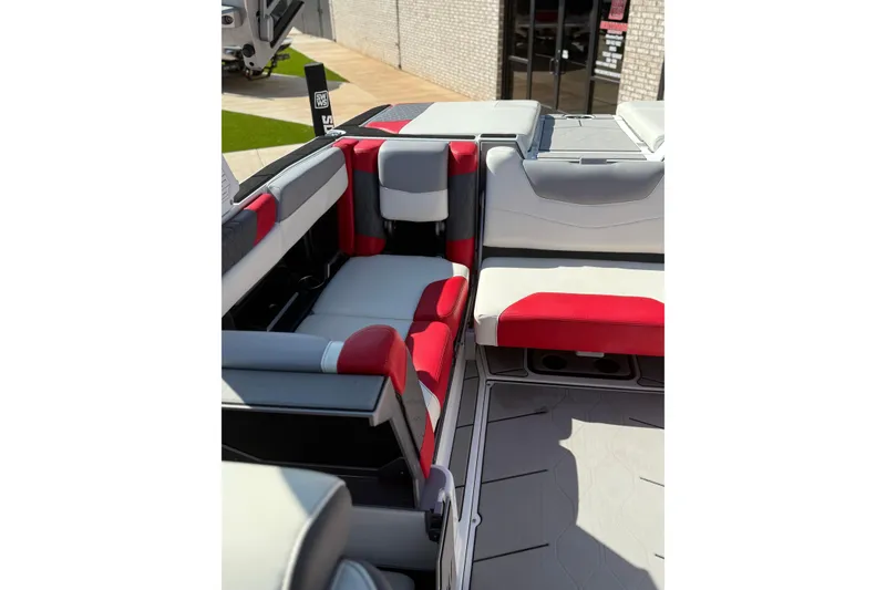 Slide: The Image of 2021 Malibu M240 boat interior with red and gray seating, showcasing modern design. - 11