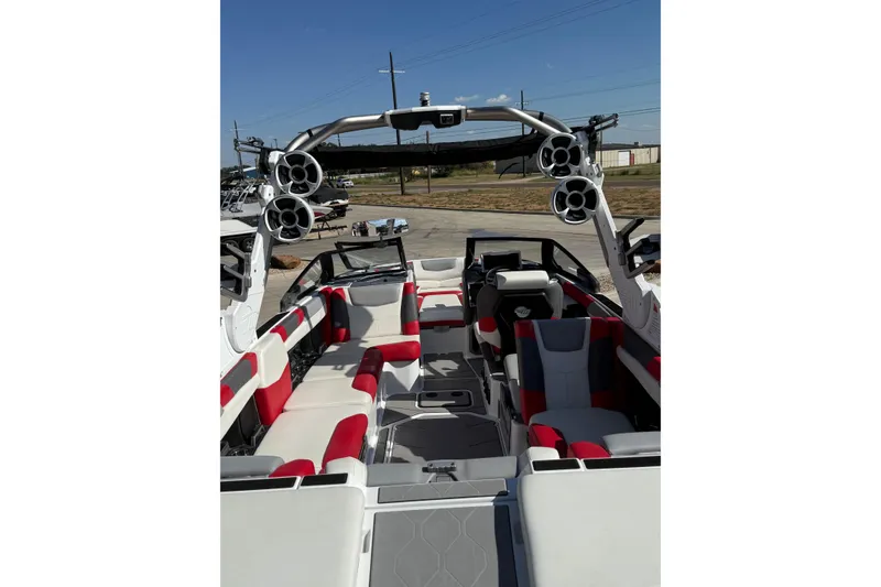 Slide: The Image of 2021 Malibu M240 boat interior with red and white seating, advanced sound system. - 5