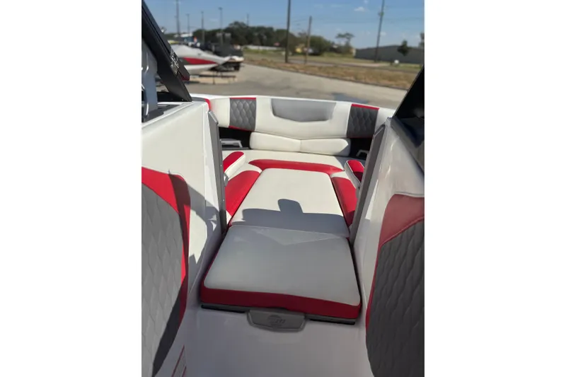 Slide: The Image of 2021 Malibu M240 boat interior with red and white seating. - 9