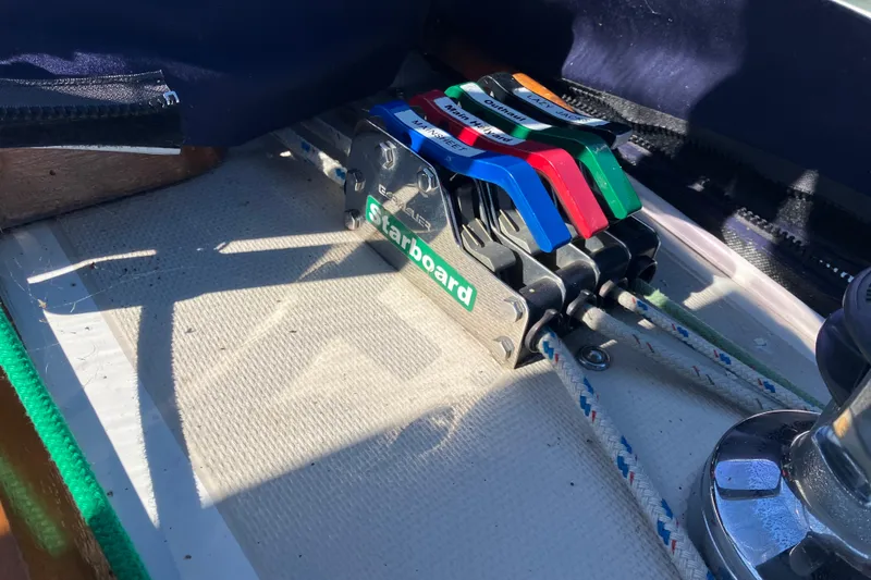 Slide: The Image of Sailing controls on a 1985 Catalina 30 boat, featuring labeled levers and ropes. - 16