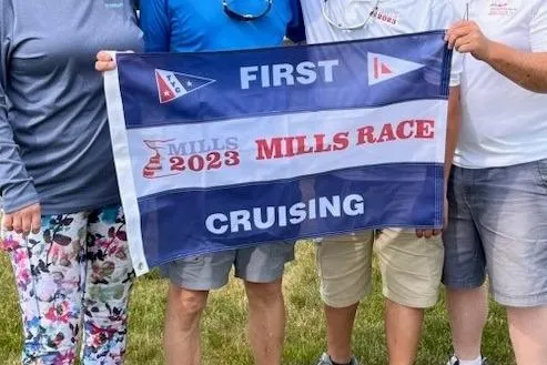 Slide: The Image of Group holding 'First Cruising' flag at 2023 Mills Race, Catalina 30, 1986. - 43