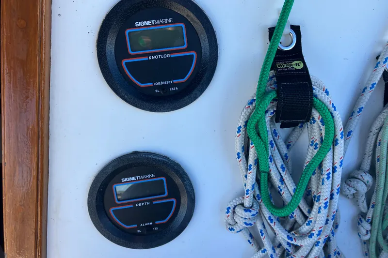 Slide: The Image of Catalina 30 sailboat instruments and ropes, featuring Signet Marine knotlog and depth gauges. - 17