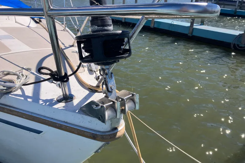 Slide: The Image of Bow of 1985 Catalina 30 sailboat with anchor and railing in marina. - 2