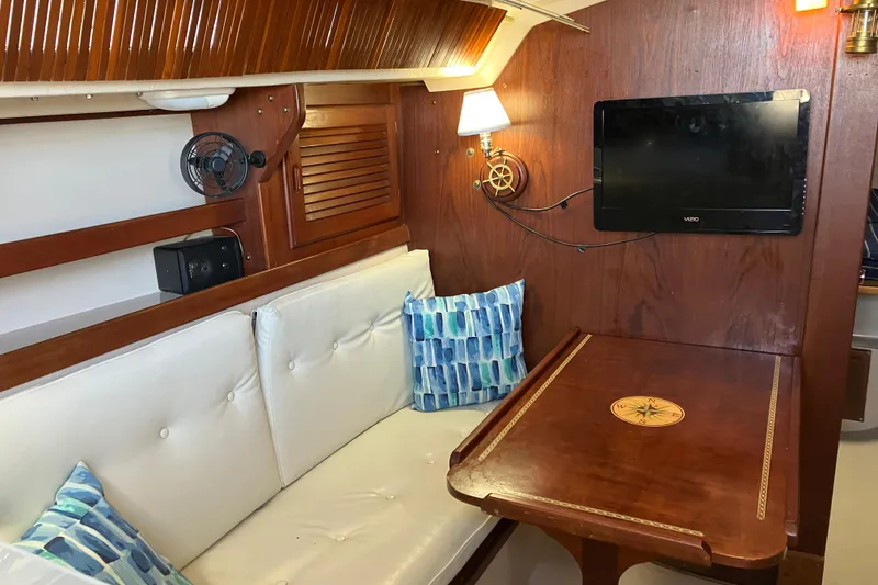Slide: The Image of Interior of a 1985 Catalina 30 sailboat with cozy seating and nautical decor. - 20