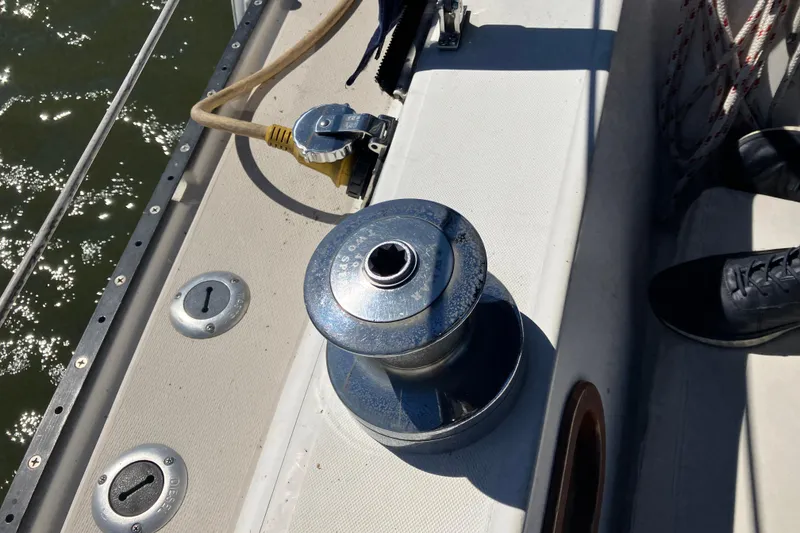 Slide: The Image of Winch on 1985 Catalina 30 sailboat deck, with water and hardware visible. - 14