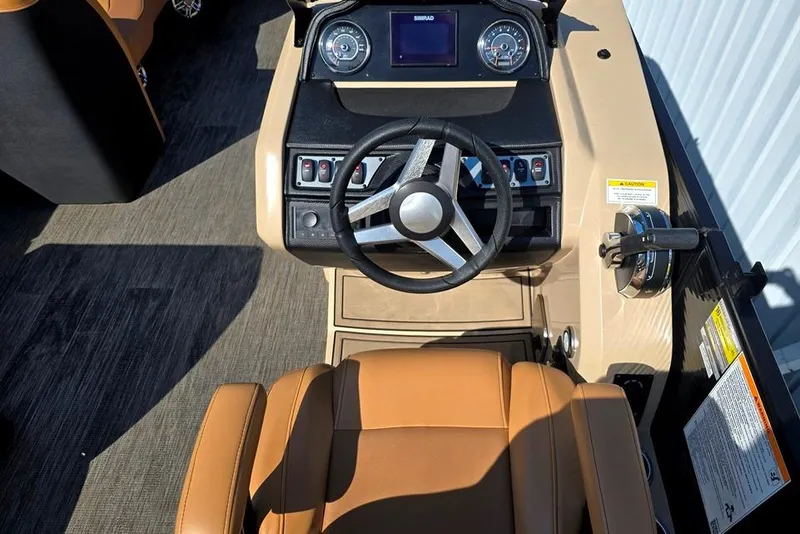 Slide: The Image of 2021 Godfrey Monaco 235 SFL boat dashboard with steering wheel and controls. - 15