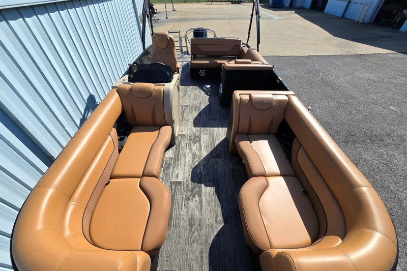 Slide: The Image of 2021 Godfrey Monaco 235 SFL pontoon boat with tan seating and spacious layout. - 2