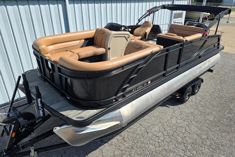 Slide: The Image of 2021 Godfrey Monaco 235 SFL pontoon boat with tan seating and black exterior. - 21