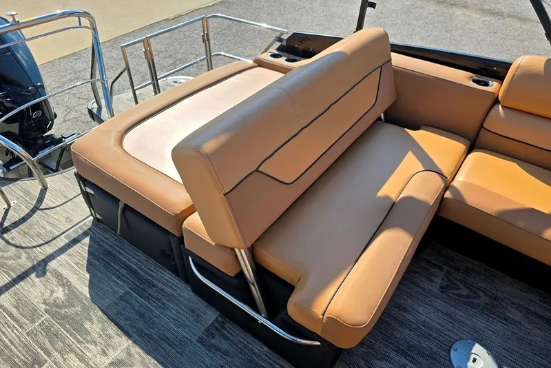 Slide: The Image of 2021 Godfrey Monaco 235 SFL boat interior with tan leather seating and metal railings. - 5