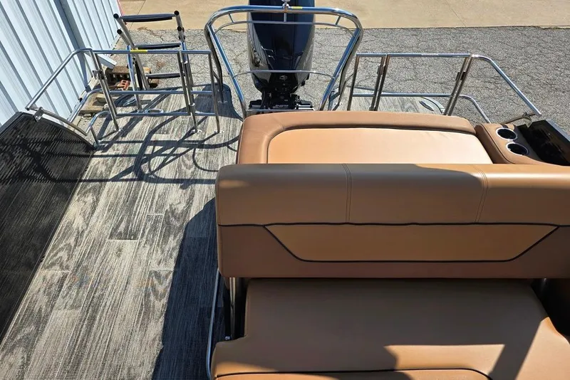 Slide: The Image of 2021 Godfrey Monaco 235 SFL boat interior with tan seating and metal railings. - 7