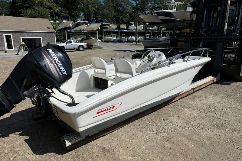Slide: The Image of 2013 Boston Whaler 150 Super Sport boat with Mercury engine on display. - 2