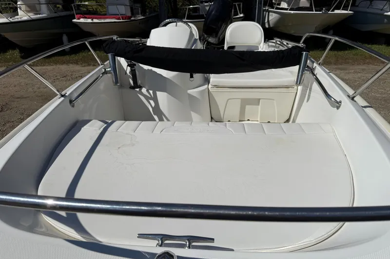 Slide: The Image of 2013 Boston Whaler 150 Super Sport boat interior with seating and railing. - 5