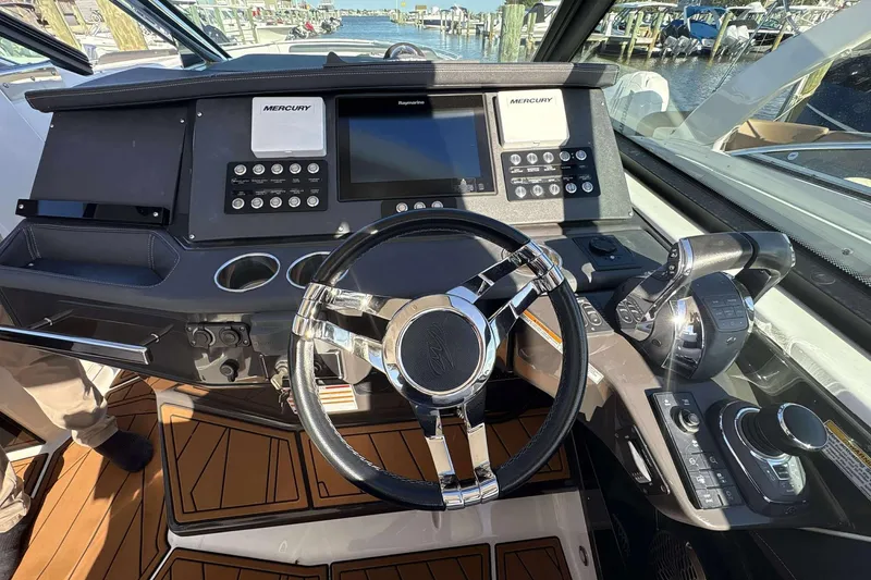 Slide: The Image of Cockpit of 2020 Monterey 378SS Super Sport boat with modern controls and steering wheel. - 10