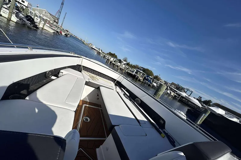 Slide: The Image of 2020 Monterey 378SS Super Sport boat with white seating, docked at a marina. - 13