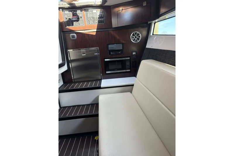 Slide: The Image of Interior of 2020 Monterey 378SS Super Sport boat with seating, appliances, and control panel. - 16