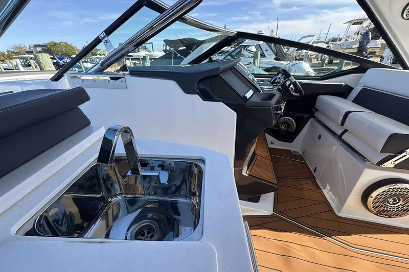 Slide: The Image of 2020 Monterey 378SS Super Sport boat interior with sink, seating, and steering console. - 24
