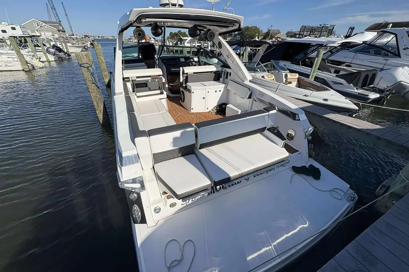 Slide: The Image of 2020 Monterey 378SS Super Sport boat docked at marina, featuring spacious seating and modern design. - 4