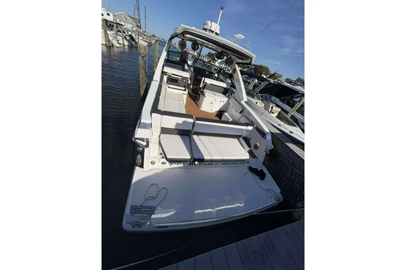 Slide: The Image of 2020 Monterey 378SS Super Sport boat docked at marina, showcasing spacious deck and seating. - 5