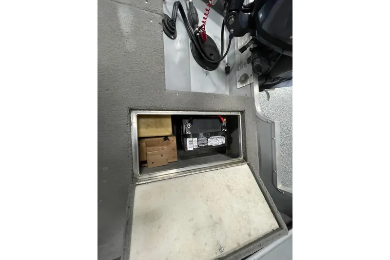 Slide: The Image of 1993 Lund 1600 Angler boat interior storage compartment with open lid. - 12