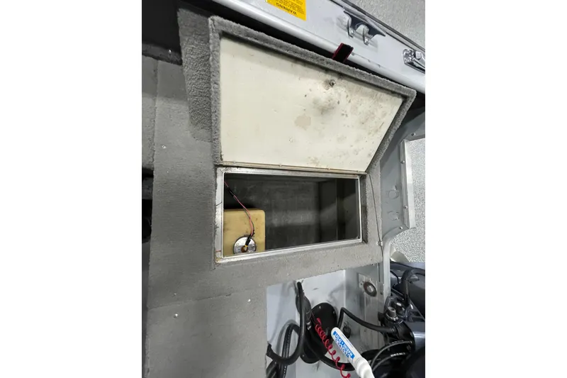 Slide: The Image of Control panel of a 1993 Lund 1600 Angler boat with switches and fire extinguisher. - 13