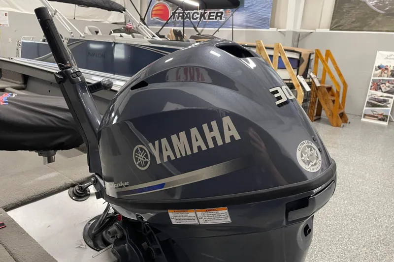 Slide: The Image of 1993 Lund 1600 Angler boat interior with swivel seat in a garage setting. - 5