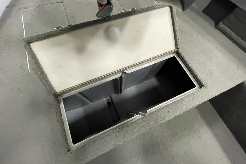 Slide: The Image of 1993 Lund 1600 Angler boat interior with open storage compartment. - 8