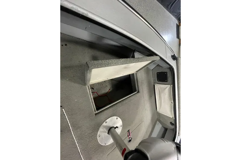 Slide: The Image of 1993 Lund 1600 Angler boat interior with open storage compartment. - 9