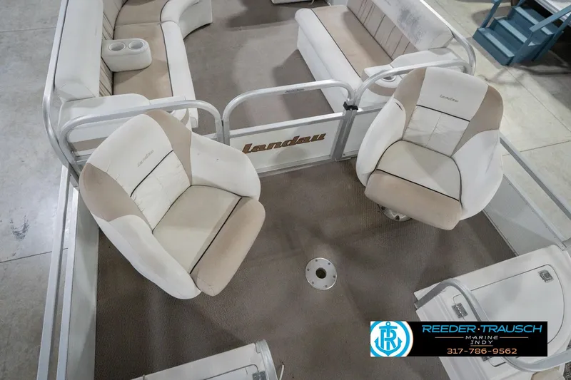Slide: The Image of Interior of a 1999 Landau DX24 boat with beige and white seating. - 13
