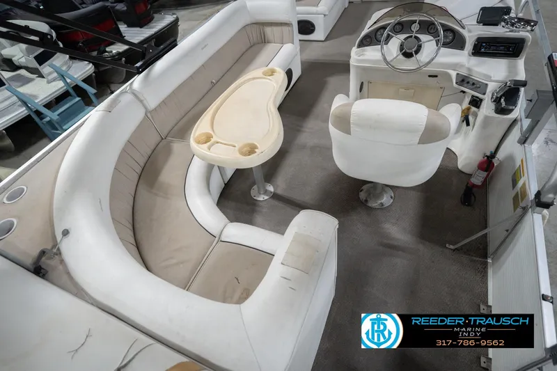 Slide: The Image of Interior of a 1999 Landau DX24 boat with seating and steering console. - 14