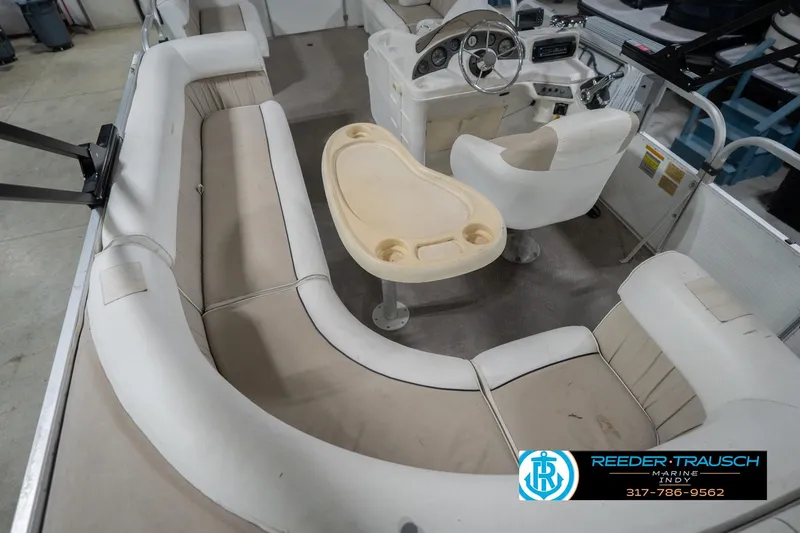 Slide: The Image of 1999 Landau DX24 boat interior with beige seating and steering console. - 15